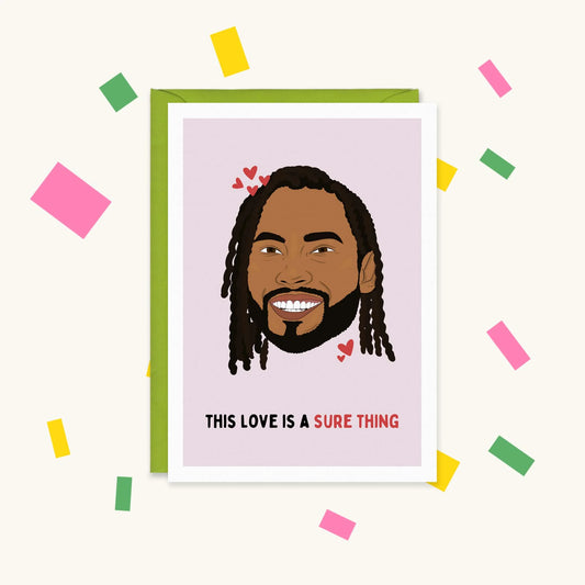 Greeting card with an illustration of singer Miguel smiling among red hearts, text "This love is a sure thing"