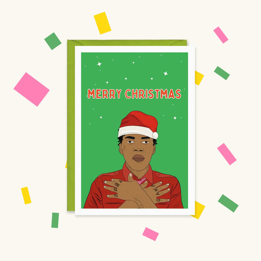 Greeting card of Vybz Kartel in a Santa hat, arms crossed over his chest on green, with the text "Merry Christmas"