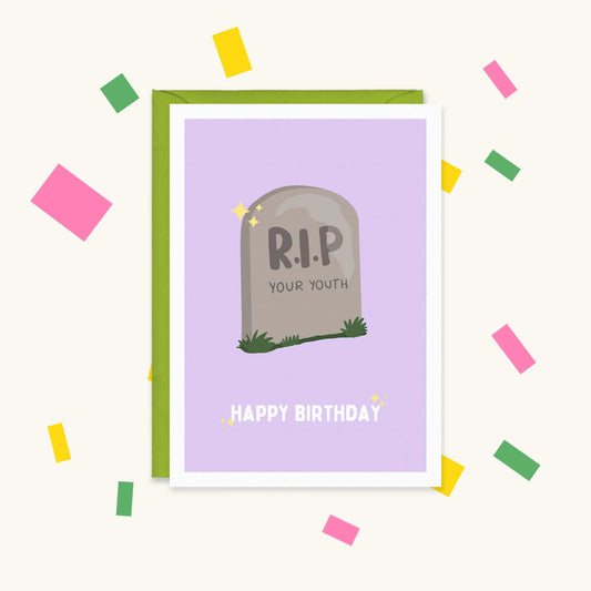 Greeting card with a cartoon gravestone on lilac reading "R.I.P your youth" and "Happy Birthday" below