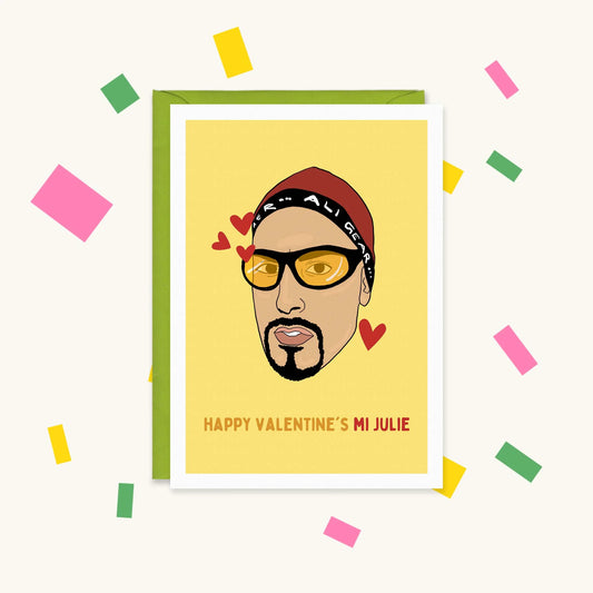 Greeting card of Ali G in yellow shades and headband with red hearts, reading 'Happy Valentine's Mi Julie'