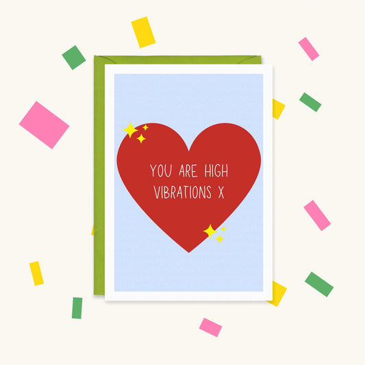 Greeting card with a big red heart and yellow sparkles on pale blue, reading "You are high vibrations x"