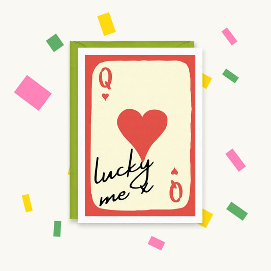 Greeting card of a red and cream Queen of Hearts playing card with a big red heart and the handwritten words "lucky me x"