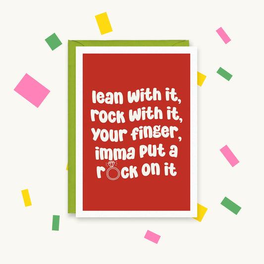 Greeting card, white text on red with a diamond ring as the O: "lean with it, rock with it, your finger, imma put a rock on it"