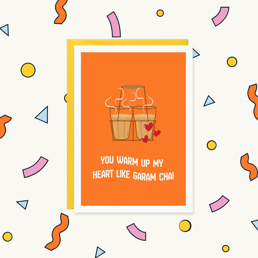 Greeting card with two steaming glasses of chai in a wire carrier with red hearts: "You warm up my heart like garam chai"
