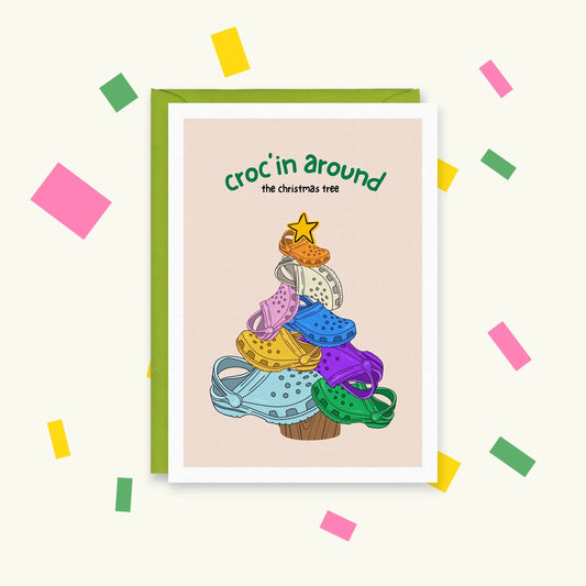 Greeting card of colourful Crocs stacked into a Christmas tree with a star on top, text "croc'in around the christmas tree"