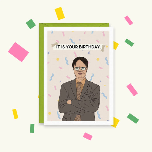 Greeting card of Dwight Schrute from The Office, arms folded among confetti, with a taped banner: "It is your birthday."