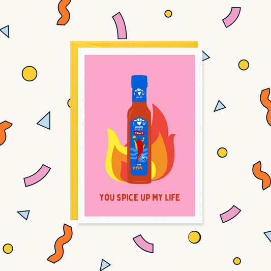 Greeting card with an Encona-style hot sauce bottle in front of flames on pink, reading "You spice up my life"