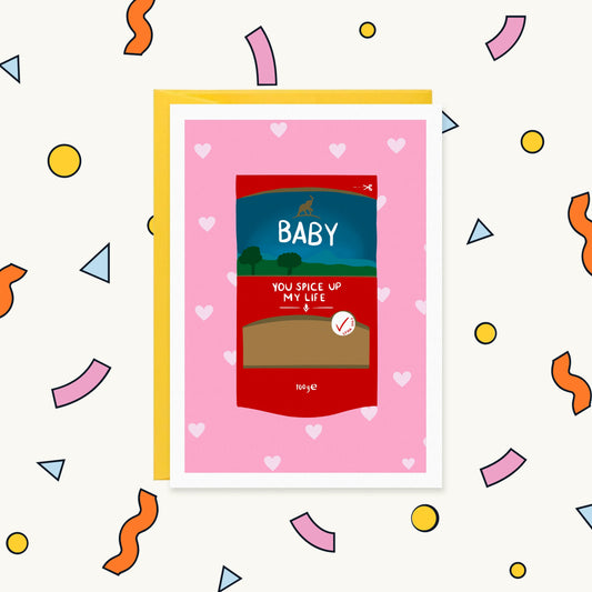 Greeting card of a red spice packet with an elephant logo on a pink heart background reading 'Baby you spice up my life'