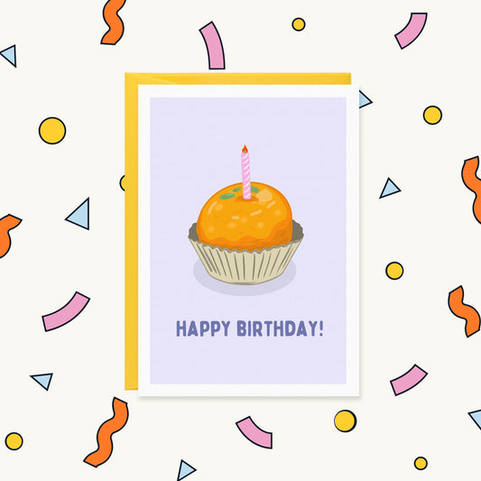 Greeting card with an orange laddoo sweet in a paper case topped with a pink candle, reading "Happy Birthday!"