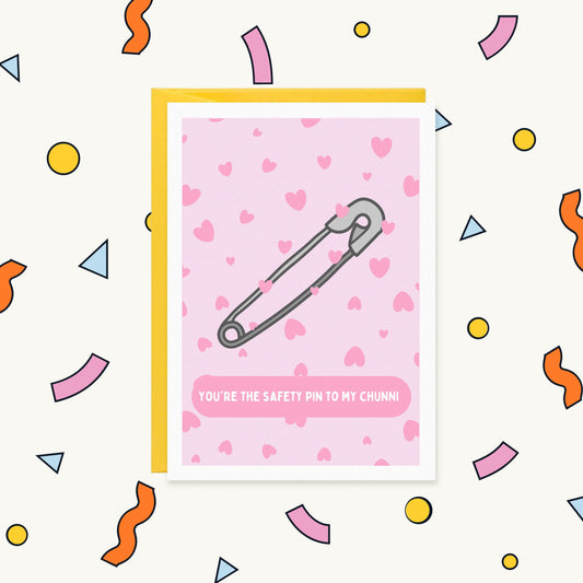 Greeting card with a silver safety pin on a pink heart pattern reading "You're the safety pin to my chunni"